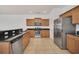 Modern kitchen with stainless steel appliances and dark countertops at 26841 Bella Vista Dr, Howey In The Hills, FL 34737