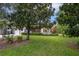 House nestled amongst large trees and greenery at 731 Midget Dr, Winter Park, FL 32789