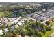 Aerial view of a house nestled in a residential neighborhood near a pond and a park at 731 Midget Dr, Winter Park, FL 32789
