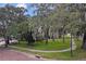 Landscaped yard with a sidewalk and mature trees at 731 Midget Dr, Winter Park, FL 32789