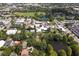 Aerial view showing a house's location near a pond, with a town in the background at 731 Midget Dr, Winter Park, FL 32789