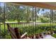 Front porch with rocking chair, potted plants, and view of nature at 731 Midget Dr, Winter Park, FL 32789