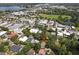 Aerial view highlighting a house's setting in a residential area near a pond and park at 731 Midget Dr, Winter Park, FL 32789