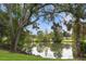 Serene pond surrounded by lush trees and vegetation at 731 Midget Dr, Winter Park, FL 32789