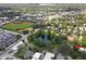 Aerial view showcasing a house near a pond and park, with a baseball field in the distance at 731 Midget Dr, Winter Park, FL 32789