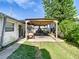 Covered patio area with outdoor pizza oven and golf cart at 610 S Laurel Ave, Sanford, FL 32771