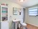 Bright bathroom with pedestal sink, toilet and shower/tub combo at 610 S Laurel Ave, Sanford, FL 32771