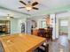 Casual dining area with a long wooden table and access to the kitchen at 610 S Laurel Ave, Sanford, FL 32771
