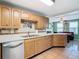 Kitchen boasts wood cabinets, tile backsplash, and stainless steel appliances at 610 S Laurel Ave, Sanford, FL 32771
