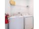 Laundry room with washer, dryer, and shelving at 951 Splash Shot Pl # 0, Davenport, FL 33896