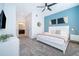 Main bedroom with king-size bed, ensuite bathroom, and neutral decor at 951 Splash Shot Pl # 0, Davenport, FL 33896