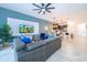 Open living room, kitchen, and dining area with tile floors and modern furnishings at 951 Splash Shot Pl # 0, Davenport, FL 33896