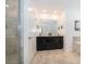 Bathroom with double vanity, large mirror, and walk-in shower at 951 Splash Shot Pl # 0, Davenport, FL 33896