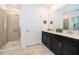 Bathroom with double vanity, walk-in shower, and neutral tile at 951 Splash Shot Pl # 0, Davenport, FL 33896