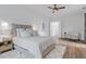 Spacious bedroom with plush bed, a sitting area and wood-look flooring at 6979 Big Bend Dr, St Cloud, FL 34771
