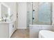 Spa-like bathroom with a walk-in shower, soaking tub, and modern fixtures at 6979 Big Bend Dr, St Cloud, FL 34771