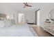 Main bedroom with king bed, ceiling fan, and a view of the bathroom at 6979 Big Bend Dr, St Cloud, FL 34771