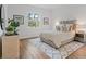 Bright bedroom with queen bed, wood-look floors, and a large window at 6979 Big Bend Dr, St Cloud, FL 34771