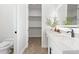 Bright bathroom featuring a toilet, vanity with a sink, and access to a walk-in closet at 6979 Big Bend Dr, St Cloud, FL 34771
