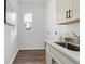 Laundry room with front-loading washer and dryer, cabinets, and a sink at 6979 Big Bend Dr, St Cloud, FL 34771
