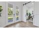 Bright entryway with double doors, barn door, and hardwood floors at 6979 Big Bend Dr, St Cloud, FL 34771