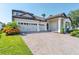 Two-story house with a three-car garage and well-maintained landscaping at 10951 Citron Oaks Dr, Orlando, FL 32836