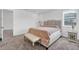 Main bedroom with beige bedding and nightstands at 10951 Citron Oaks Dr, Orlando, FL 32836