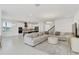 Open floor plan with a large sectional sofa and modern kitchen at 10951 Citron Oaks Dr, Orlando, FL 32836
