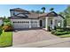 Two-story home with tile roof and paver driveway at 10951 Citron Oaks Dr, Orlando, FL 32836