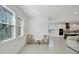 Bright breakfast room with two chairs and a view into the kitchen at 10951 Citron Oaks Dr, Orlando, FL 32836