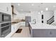 Open concept kitchen boasting white cabinets, an island, and stainless steel appliances at 10951 Citron Oaks Dr, Orlando, FL 32836