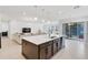 Open concept kitchen and living room with large island and sectional sofa at 10951 Citron Oaks Dr, Orlando, FL 32836