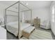 Main bedroom with canopy bed, dresser, and crib at 10951 Citron Oaks Dr, Orlando, FL 32836