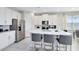 Modern kitchen boasts white cabinets, marble countertops, and stainless steel appliances at 7443 Marker Ave, Kissimmee, FL 34747