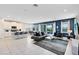 Open living room features a gray sectional sofa, glass coffee table, and large TV at 7443 Marker Ave, Kissimmee, FL 34747