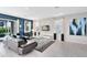Relaxing living room with gray sectional sofa, glass coffee table, and large TV at 7443 Marker Ave, Kissimmee, FL 34747