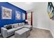 Fun game room with sectional sofa, movie posters, and large TV at 7443 Marker Ave, Kissimmee, FL 34747