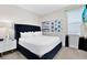 Elegant bedroom with king-size bed and dark blue headboard at 7443 Marker Ave, Kissimmee, FL 34747