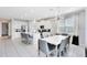 Bright dining area features a white table with gray chairs and a modern chandelier at 7443 Marker Ave, Kissimmee, FL 34747