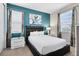 Bedroom with a queen-size bed and teal accent wall at 7443 Marker Ave, Kissimmee, FL 34747