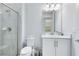 Clean bathroom with white vanity, marble countertop, and glass shower at 7443 Marker Ave, Kissimmee, FL 34747