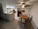 Dining area with table and chairs, adjacent to kitchen at 5587 Devonbriar Way # 105, Orlando, FL 32822