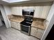 Kitchen with granite countertops and stainless steel range at 5587 Devonbriar Way # 105, Orlando, FL 32822