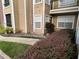 Exterior view of building and landscaping at 5587 Devonbriar Way # 105, Orlando, FL 32822