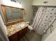 Clean bathroom with granite countertop and shower/tub combo at 5587 Devonbriar Way # 105, Orlando, FL 32822