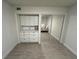 Bright bedroom with mirrored closet and built-in shelving at 5587 Devonbriar Way # 105, Orlando, FL 32822
