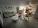 Living room with comfortable seating and view to dining area at 5587 Devonbriar Way # 105, Orlando, FL 32822