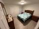 Bright bedroom featuring a queen bed and wood furniture at 5587 Devonbriar Way # 105, Orlando, FL 32822