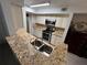 Kitchen with granite countertops and stainless steel appliances at 5587 Devonbriar Way # 105, Orlando, FL 32822