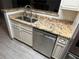 Kitchen with granite countertops and stainless steel dishwasher at 5587 Devonbriar Way # 105, Orlando, FL 32822